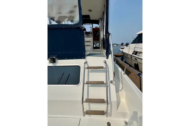 Rosie Mclane Yacht Photos Pics Staircase on a 2006 Westcoast Sedan boat, docked near other vessels.