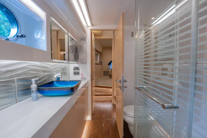 Passion Yacht Photos Pics Luxurious bathroom interior on 2019 Horizon PC52 yacht with modern fixtures and blue sink.