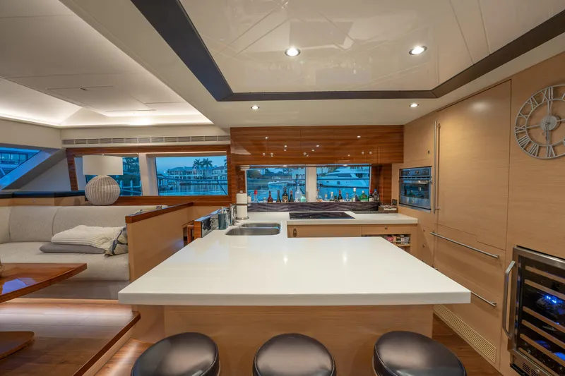 Passion Yacht Photos Pics Luxurious interior of 2019 Horizon PC52 yacht with modern kitchen and seating area.