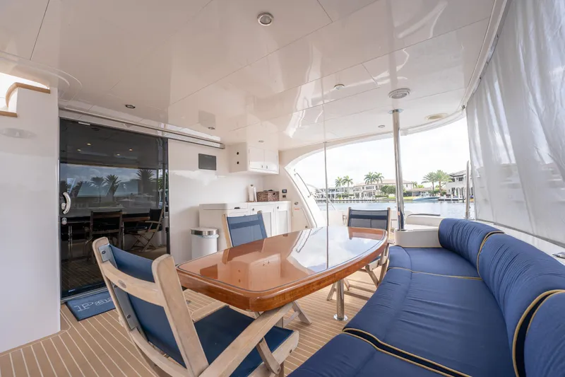 Passion Yacht Photos Pics Luxurious 2019 Horizon PC52 yacht deck with elegant seating and waterfront view.