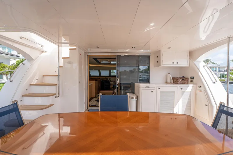 Passion Yacht Photos Pics Luxurious 2019 Horizon PC52 yacht interior with dining area, stairs, and cabinetry.