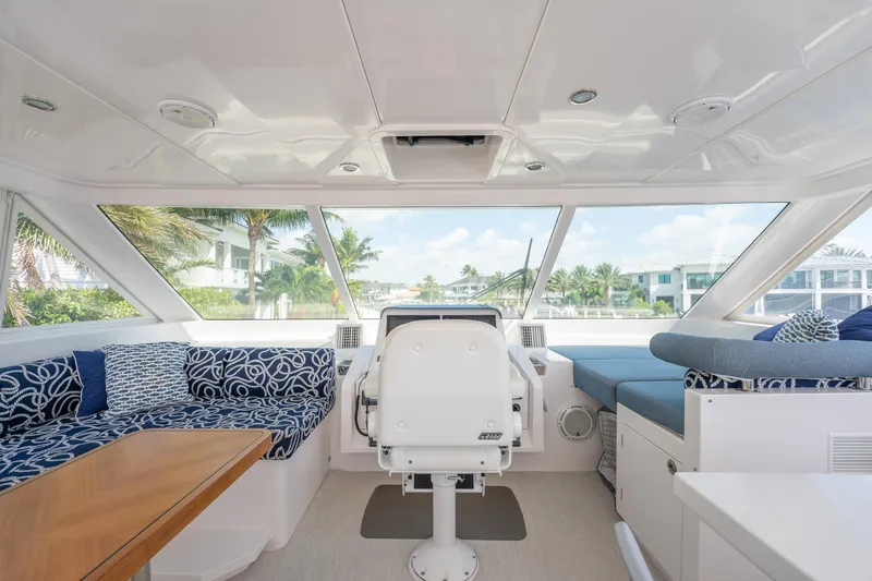 Passion Yacht Photos Pics Interior of 2019 Horizon PC52 yacht with plush seating and panoramic windows.