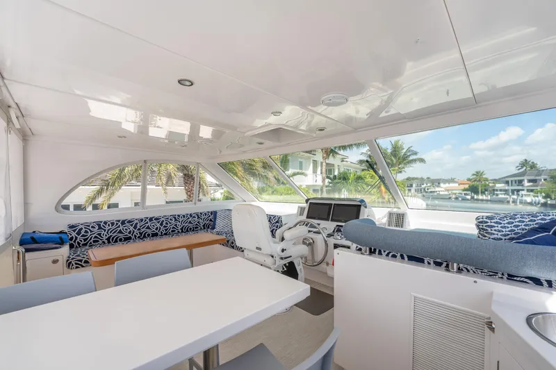 Passion Yacht Photos Pics Luxurious interior of 2019 Horizon PC52 yacht with modern helm and seating area.