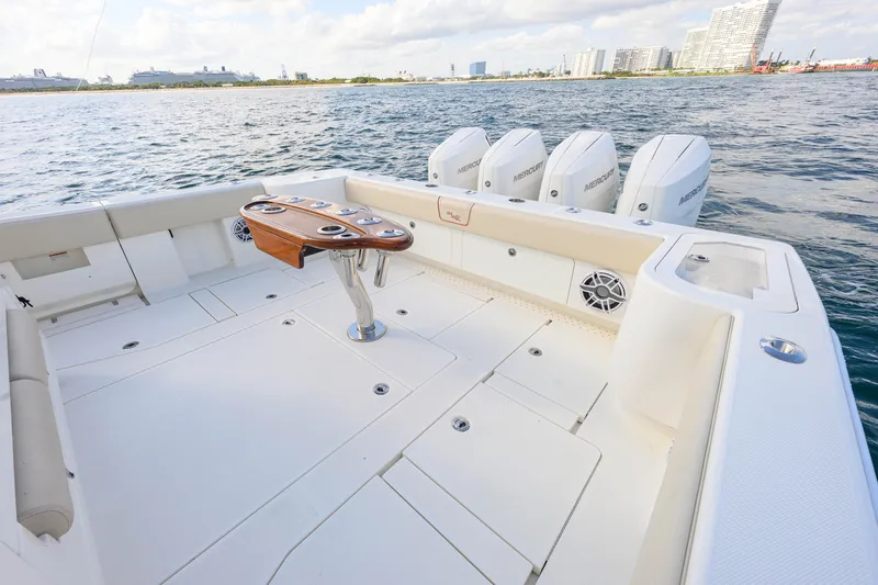  Yacht Photos Pics 2022 SeaVee 450Z boat deck with quad Mercury engines, spacious layout, and ocean view.