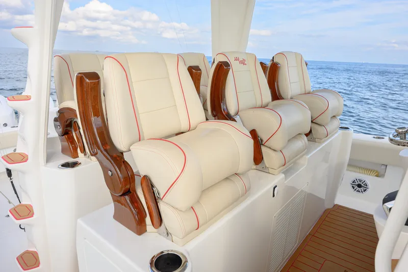  Yacht Photos Pics Luxurious seating on 2022 SeaVee 450Z boat, featuring plush cream cushions and wooden accents.