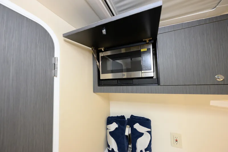  Yacht Photos Pics 2022 SeaVee 450Z interior with microwave and stylish cabinetry.