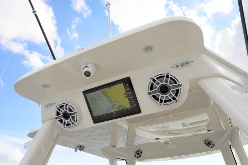  Yacht Photos Pics 2022 SeaVee 450Z boat console with speakers and navigation screen under blue sky.