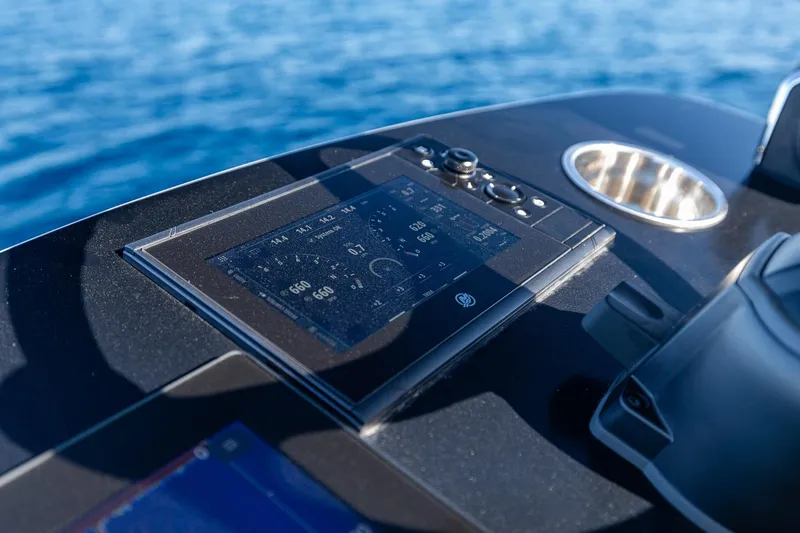  Yacht Photos Pics Control panel of 2026 SeaVee 420Z boat with digital display, on calm blue water.