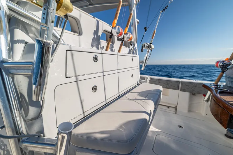  Yacht Photos Pics 2026 SeaVee 420Z fishing boat with rods, ocean view, and seating area.