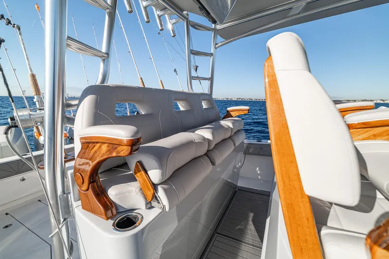  Yacht Photos Pics Luxurious seating on 2026 SeaVee 420Z boat with ocean backdrop and fishing rods.