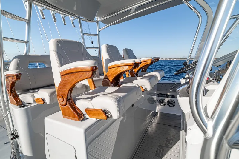  Yacht Photos Pics Luxury seating on 2026 SeaVee 420Z boat, featuring elegant wooden armrests and ocean backdrop.