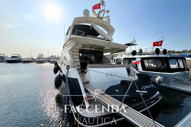  Yacht Photos Pics 2008 Princess 67 Flybridge yacht docked at marina with jet ski on platform.