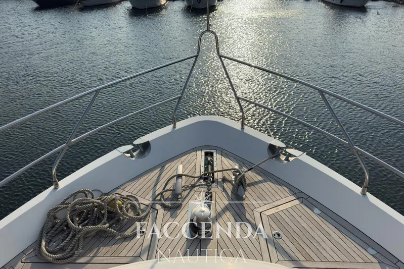  Yacht Photos Pics Bow view of 2008 Princess 67 Flybridge yacht on calm water.