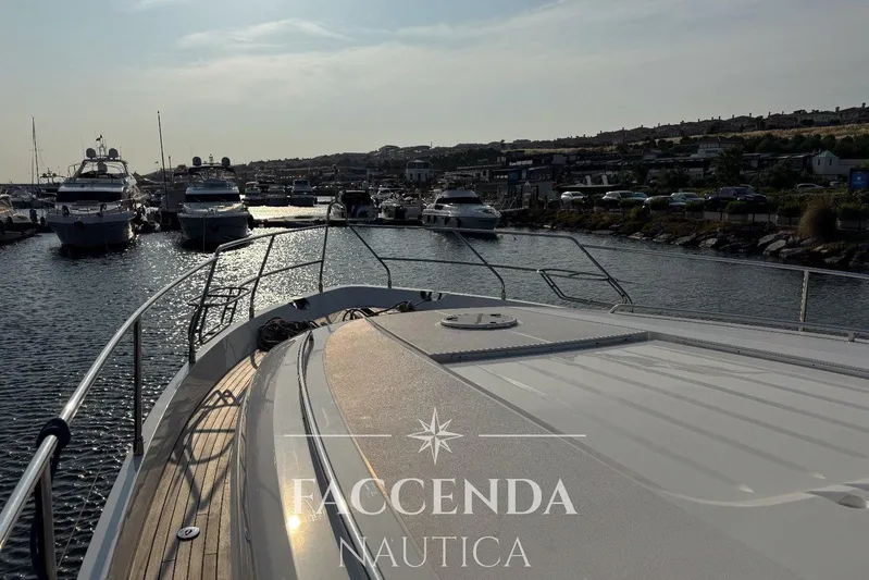  Yacht Photos Pics 2008 Princess 67 Flybridge yacht docked in a marina, surrounded by other boats.