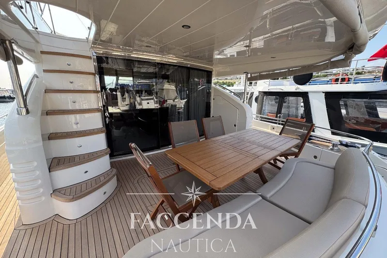  Yacht Photos Pics Luxurious 2008 Princess 67 Flybridge yacht with elegant outdoor seating and staircase.