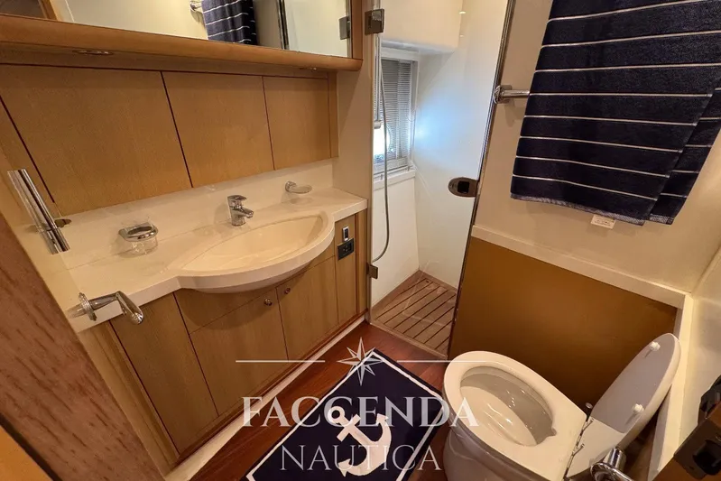 Yacht Photos Pics Luxurious bathroom in 2008 Princess 67 Flybridge yacht with modern fixtures and wooden accents.