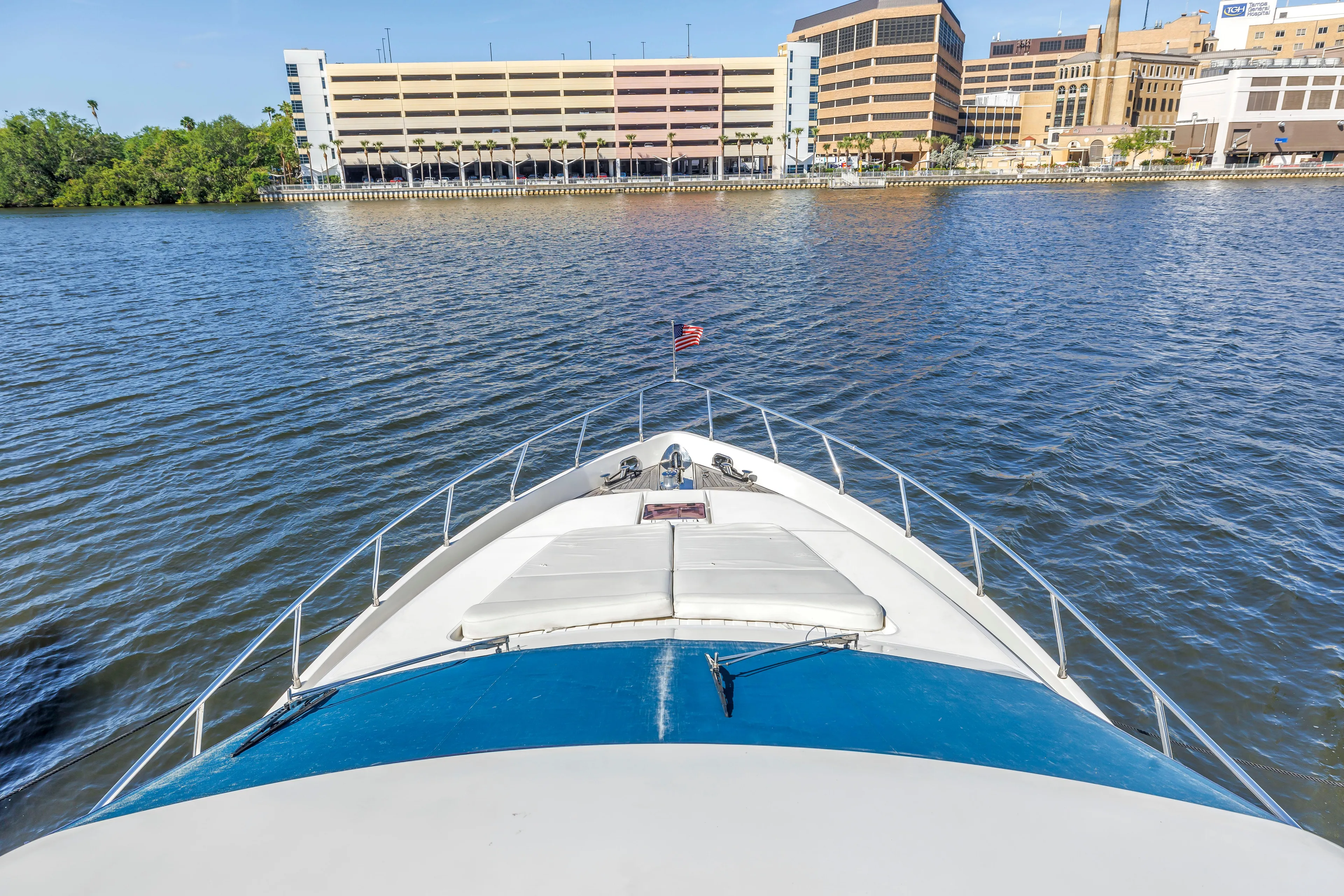 Solaris Yacht Photos Pics Bow view of 2009 Uniesse 65 MY yacht approaching urban waterfront.