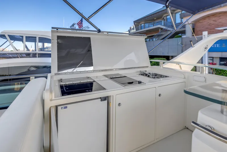 Solaris Yacht Photos Pics Outdoor kitchen on 2009 Uniesse 65 MY yacht with stove, sink, and fridge.