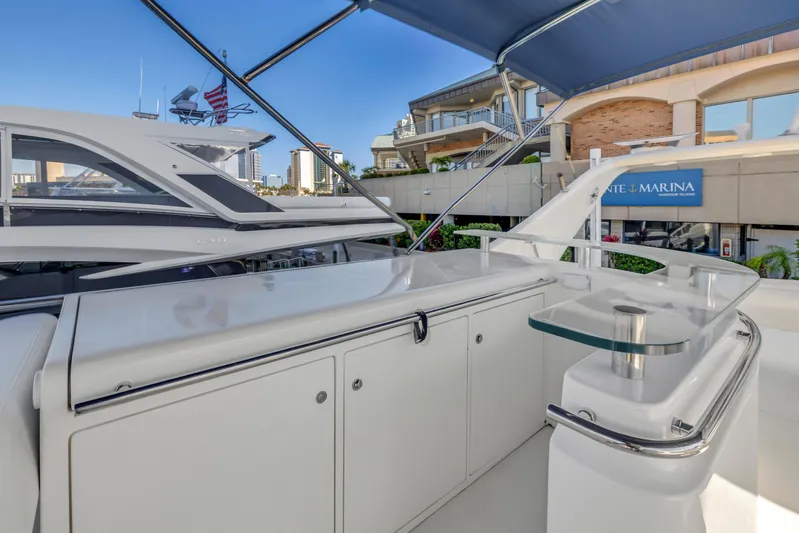 Solaris Yacht Photos Pics 2009 Uniesse 65 MY yacht deck with sleek design and marina backdrop.