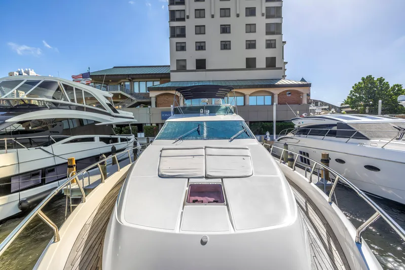 Solaris Yacht Photos Pics 2009 Uniesse 65 MY yacht docked at marina, surrounded by other luxury boats.