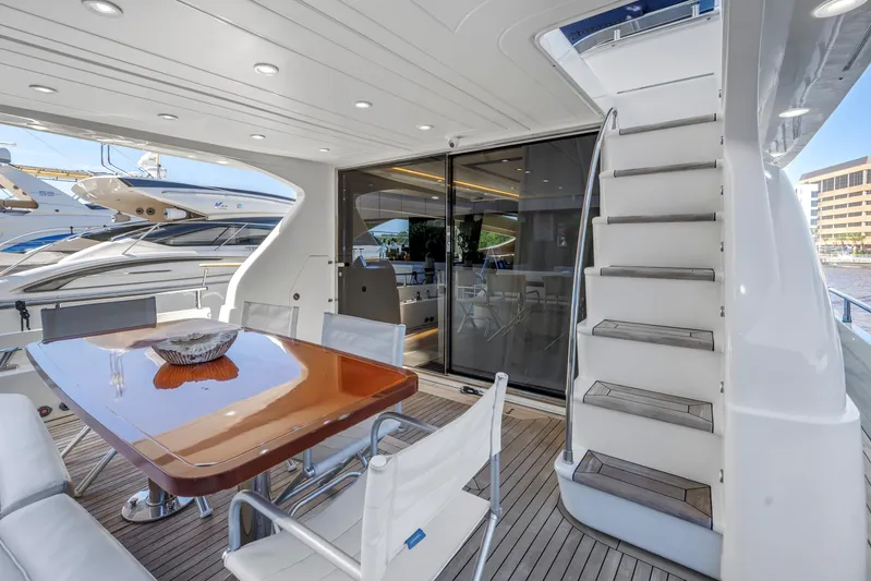 Solaris Yacht Photos Pics Luxury yacht Uniesse 65 MY 2009 with elegant outdoor dining area and staircase.