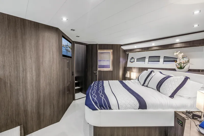 Solaris Yacht Photos Pics Luxurious bedroom interior of 2009 Uniesse 65 MY yacht with modern decor and elegant bedding.