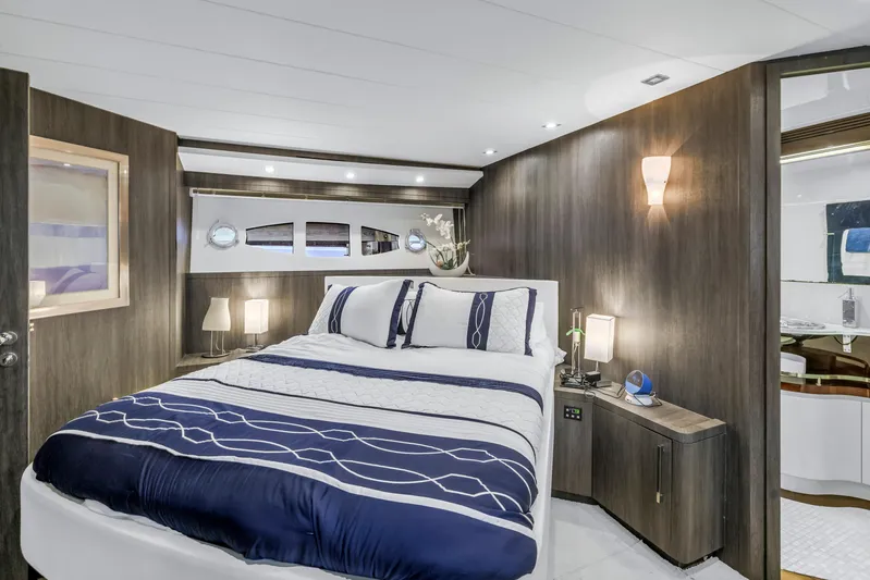 Solaris Yacht Photos Pics Luxurious bedroom interior of 2009 Uniesse 65 MY yacht with modern decor and elegant lighting.