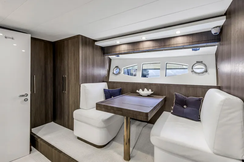 Solaris Yacht Photos Pics Luxurious interior of 2009 Uniesse 65 MY yacht with elegant seating and table.
