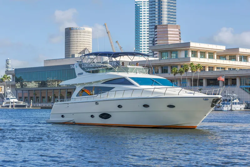 Solaris Yacht Photos Pics 2009 Uniesse 65 MY yacht cruising near urban waterfront buildings.