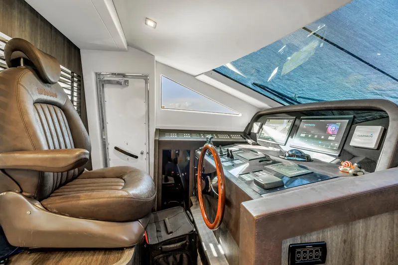 Solaris Yacht Photos Pics Luxurious 2009 Uniesse 65 MY yacht helm with leather captain's chair and advanced navigation controls.