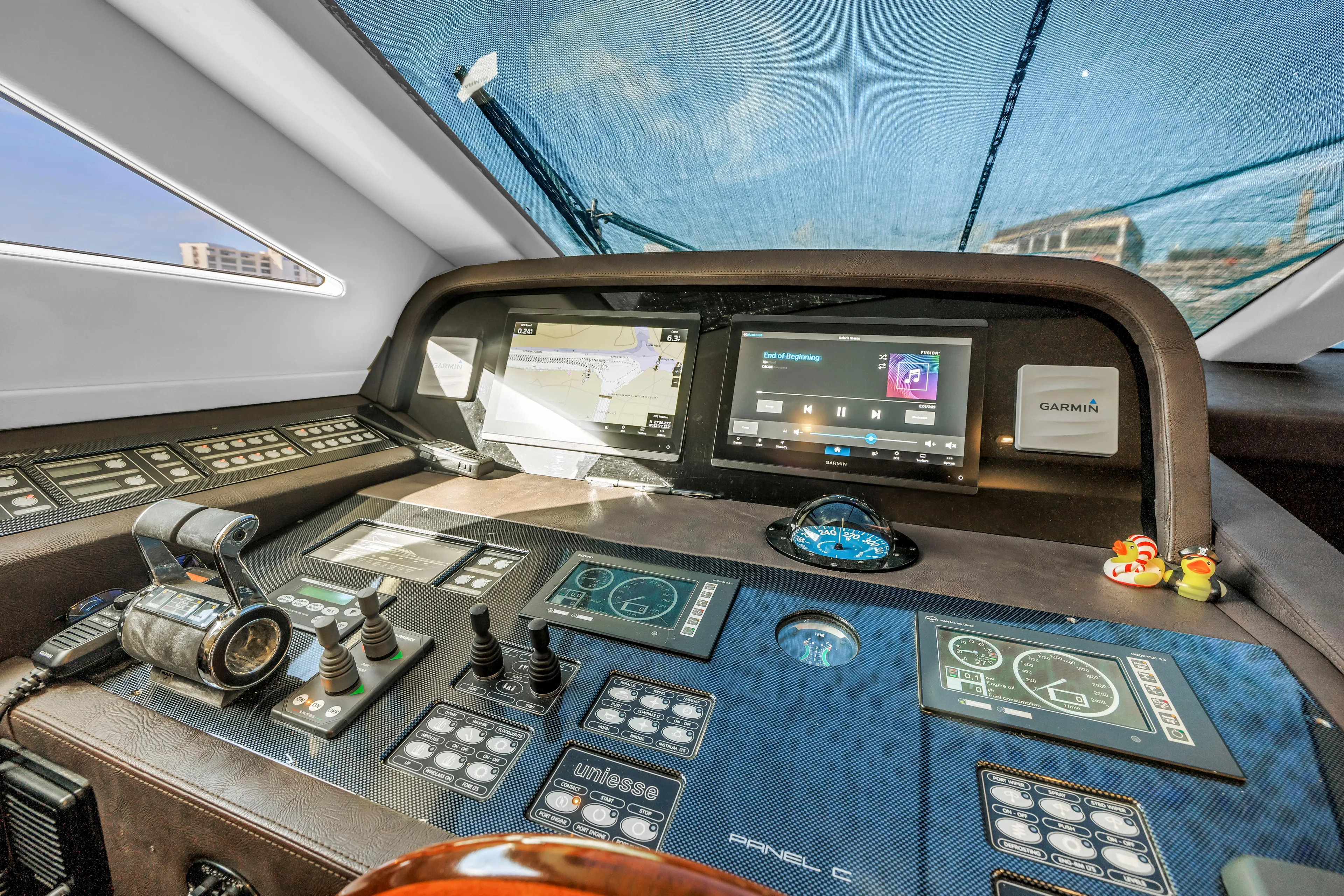 Solaris Yacht Photos Pics Control panel of 2009 Uniesse 65 MY yacht with navigation screens and instruments.