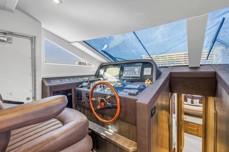 Solaris Yacht Photos Pics 2009 Uniesse 65 MY yacht helm with leather seating and modern navigation controls.