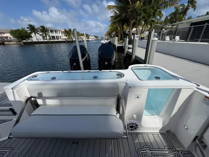 Keri B III Yacht Photos Pics 2023 Sea Fox 328 Commander boat with seating and dual engines docked by a waterfront.