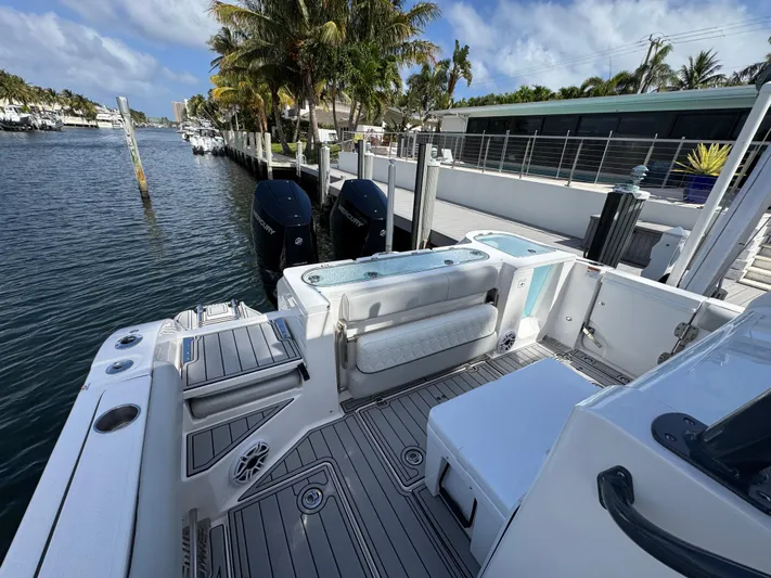 Keri B III Yacht Photos Pics 2023 Sea Fox 328 Commander boat docked by a waterfront home, featuring dual engines.