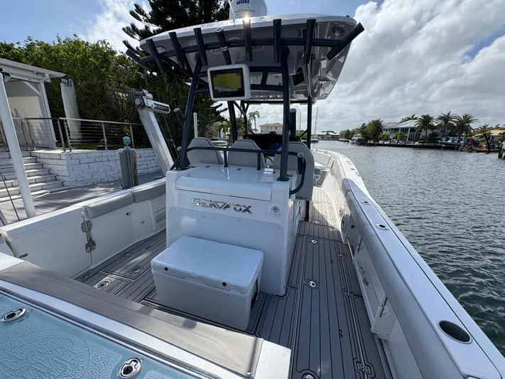 Keri B III Yacht Photos Pics 2023 Sea Fox 328 Commander boat docked by a scenic waterfront.