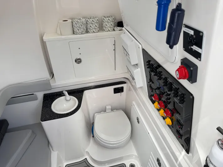 Keri B III Yacht Photos Pics 2023 Sea Fox 328 Commander boat interior with toilet and control panel.