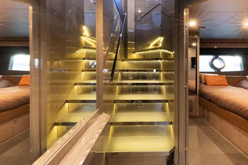  Yacht Photos Pics Luxurious interior of 2013 Sunseeker 28 Metre Yacht with illuminated staircase and cozy bedrooms.