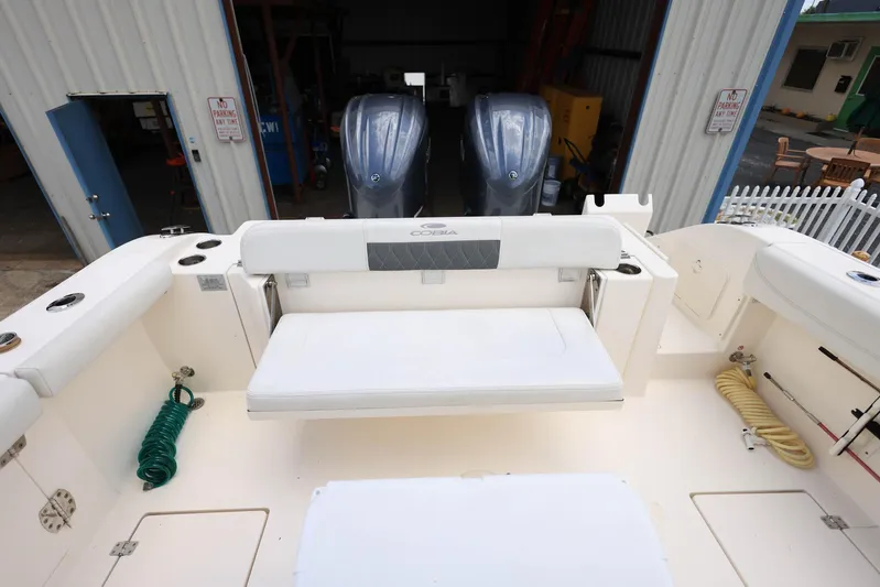  Yacht Photos Pics 2022 Cobia 301 Center Console boat with dual engines and spacious seating area.