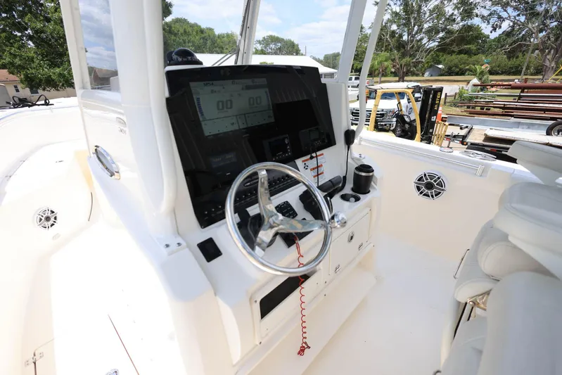 Yacht Photos Pics 2022 Cobia 301 Center Console boat dashboard with steering wheel and controls.