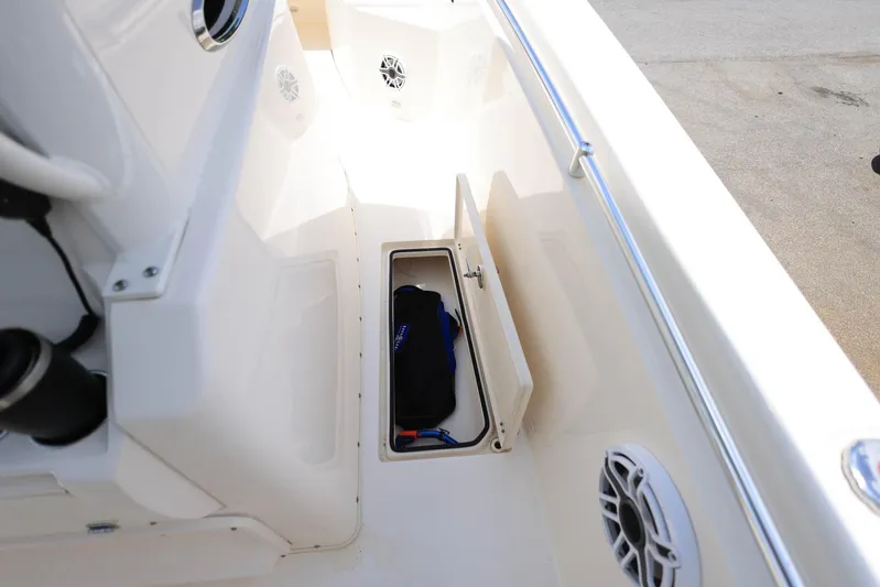  Yacht Photos Pics 2022 Cobia 301 Center Console boat with open storage compartment and speakers.