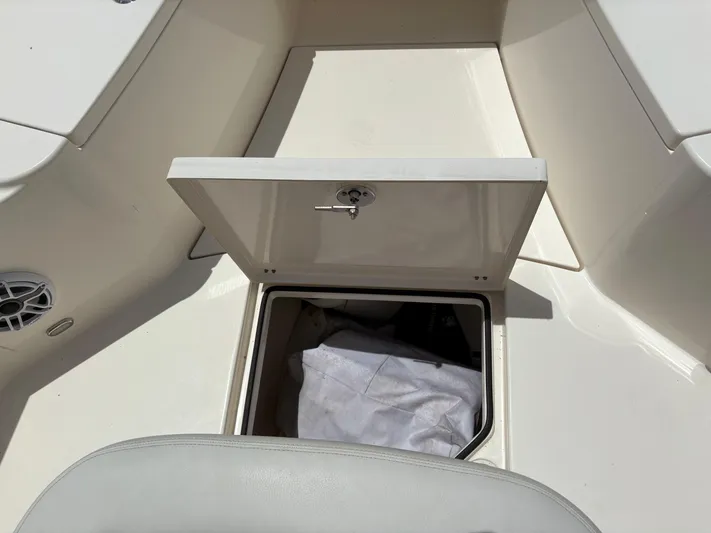  Yacht Photos Pics 2022 Cobia 301 Center Console storage compartment with open hatch, revealing interior space.