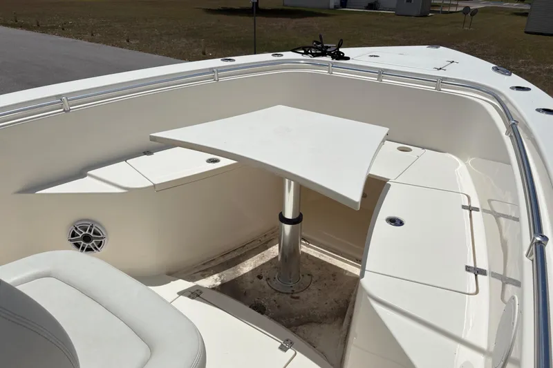  Yacht Photos Pics 2022 Cobia 301 Center Console boat with seating and table in the bow area.