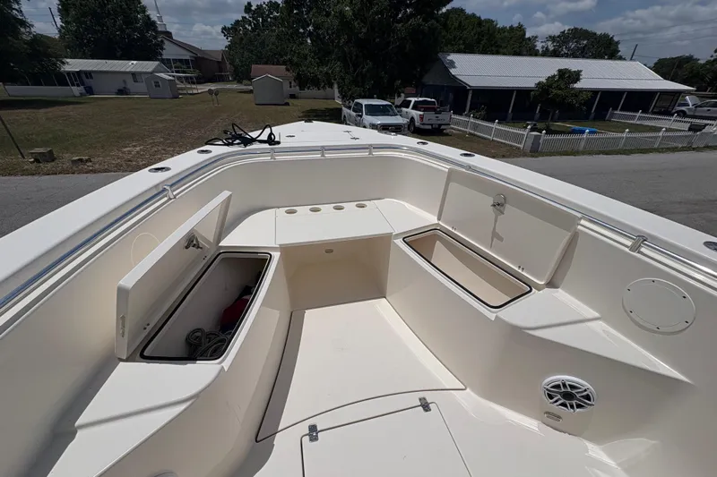 Yacht Photos Pics 2022 Cobia 301 Center Console boat with open storage compartments and seating area.