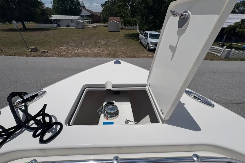  Yacht Photos Pics 2022 Cobia 301 Center Console boat with open storage compartment on deck.