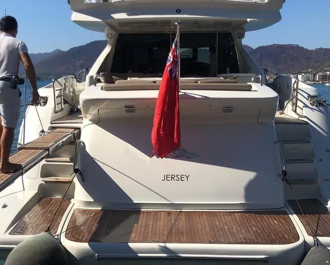  Yacht Photos Pics 2006 Azimut 86S yacht with Jersey flag, docked in a scenic marina.