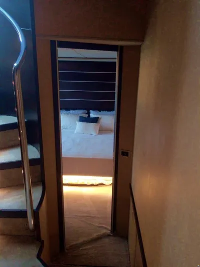  Yacht Photos Pics Interior view of 2006 Azimut 86S yacht, featuring a cozy bedroom and elegant staircase.