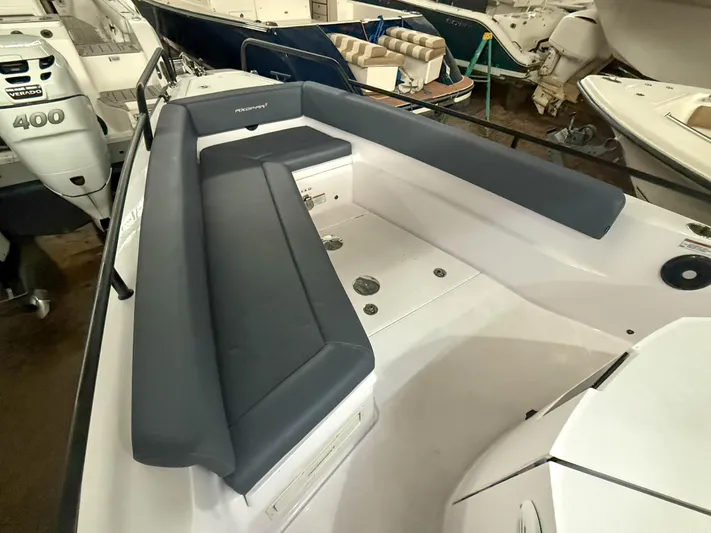 Underestimated Yacht Photos Pics 2021 Axopar 28 CABIN boat interior with cushioned seating and modern design.
