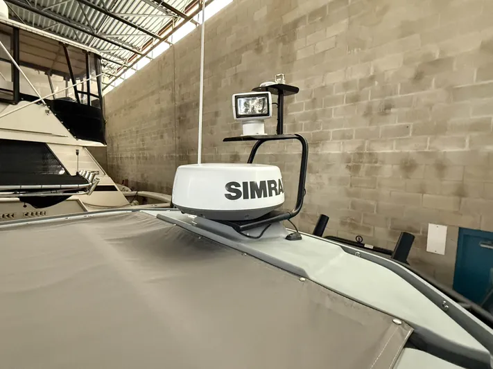 Underestimated Yacht Photos Pics Simrad radar on 2021 Axopar 28 CABIN boat in storage facility.
