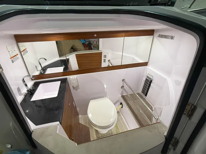 Underestimated Yacht Photos Pics 2021 Axopar 28 CABIN bathroom with modern fixtures and sleek design.