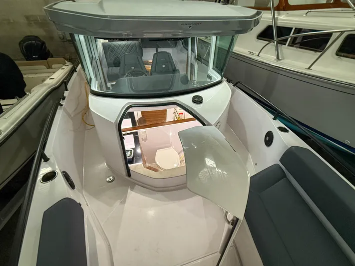 Underestimated Yacht Photos Pics 2021 Axopar 28 CABIN boat interior with seating and cabin view.